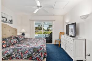 a bedroom with a bed and a dresser with a tv at Triple En-Suite Pool Retreat - All Master Bedrooms in Inverness +10 photos