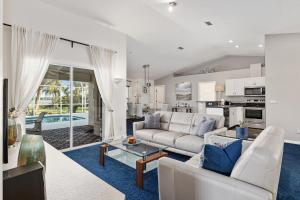 a living room with a couch and a table at Triple En-Suite Pool Retreat - All Master Bedrooms in Inverness