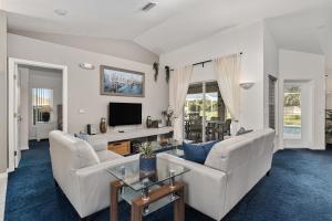a living room with two white couches and a tv at Triple En-Suite Pool Retreat - All Master Bedrooms in Inverness