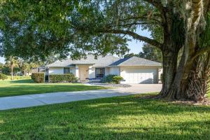 a house with a tree and a driveway at Triple En-Suite Pool Retreat - All Master Bedrooms in Inverness