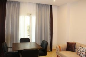 a living room with a table and a couch at Andalusia Blue Beach Hurghada in Hurghada