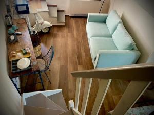 a living room with a blue couch and a table at La Casina di Venere in Savoca
