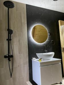 a bathroom with a sink and a mirror at Cozy Cottage Dilijan Arg in Dilijan