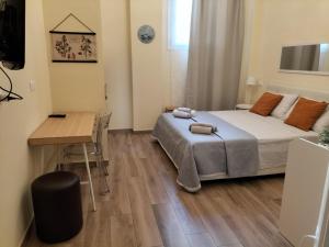 a bedroom with a bed and a table and a desk at BolognaFiera in Bologna