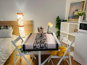 a table and chairs in a room at Dream Dwell Paris- The 6th district Paris Historical apartment near Montparnasse in Paris