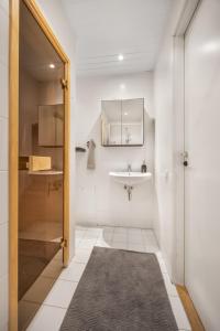 a bathroom with a sink and a mirror at Vilmsi 41 Apartment in Tallinn