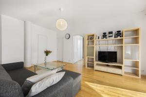 a living room with a couch and a television at Vilmsi 41 Apartment in Tallinn