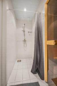 a bathroom with a shower with a shower curtain at Vilmsi 41 Apartment in Tallinn