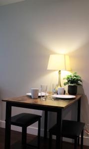 a wooden table with a lamp and a plant on it at The Après Suite in Whistler