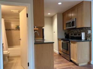 a kitchen with a sink and a stove top oven at The Après Suite in Whistler