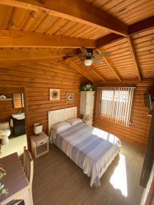 1 dormitorio con 1 cama en una habitación de madera en Cabañas Tr'eje, en Valle de Bravo