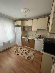 a kitchen with a white refrigerator and a stove at Çift klimalı, 110m2, 3+1, metro 5dk, 1000mbps inte in Karşıyaka