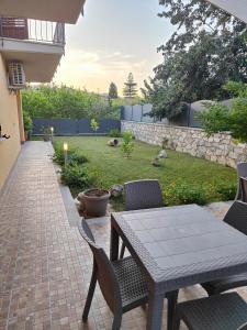 a patio with a table and chairs and a yard at B&B Villa Chiara Bed and Breakfast in Taormina