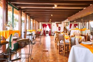 a dining room with tables and chairs and yellow tablecloths at Best Western Majestic in Mexico City