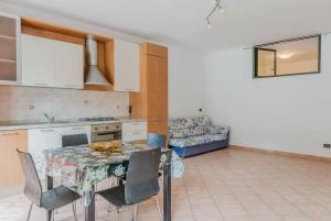 a kitchen with a table and chairs and a couch at [relax in nature and lake] free parking in Luino +12 photos