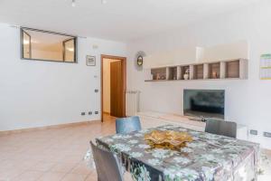 a dining room with a table and a television at [relax in nature and lake] free parking in Luino