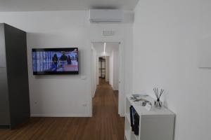 a living room with a television on a wall at Villa Riviera 287 in Pescara
