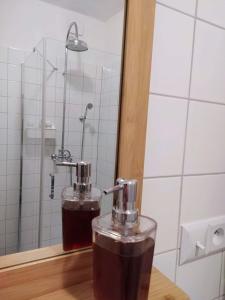 a drink in a glass on a table in a bathroom at Vejminek Malý Statek in Slavče