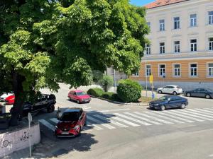 a parking lot with cars parked in front of a building at Anna in Livno