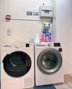 a washing machine and a washer in a room at Large Quiet Whole House near Historic Gent Centre in Ghent
