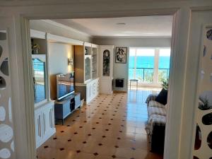 a living room with a view of the ocean at FirstLine BeachView in El Campello