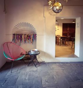 a room with a chair and a table with a fan at Santa Josefita B&B in Cholula