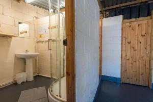 a bathroom with a shower and a sink at Exmoor Lodge (Oak Tree Lane) in Okehampton