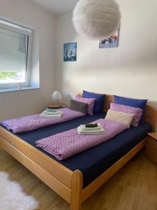 a bedroom with two beds with purple pillows at Anna in Livno