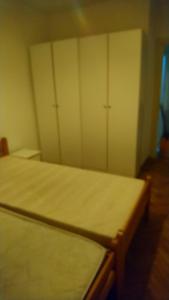 a room with two beds and two closets at Apartman Aurora in Ledine
