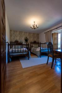 a bedroom with two beds and a chandelier at CASA DE PARDO in A Coruña