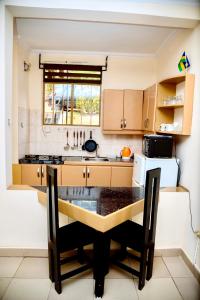 a kitchen with a island in the middle at Cosy Hidden Gem in Kigali