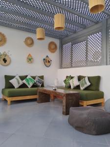 a living room with two couches and a table at Riad L'Arganier in Marrakech