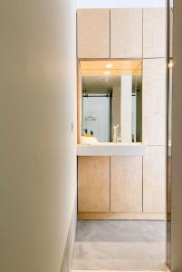 a bathroom with a sink and a mirror at Casa do Rio in Leiria