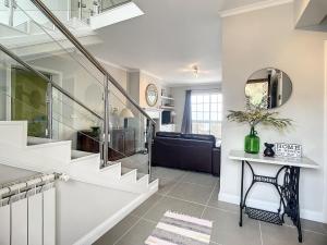 a living room with a staircase and a couch at Vinhaticos Villa by Atlantic Holiday in Porto Moniz +41 photos
