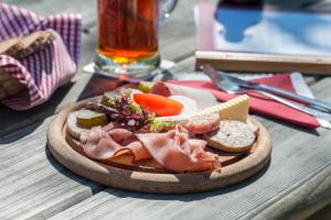 a plate of food with meat and vegetables on a table at Brauereigasthof Rothenbach in Aufseß