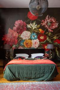 ベルリンにあるアールヌーボー ホテル アム クアフュルステンダムの花の壁のベッドルーム(ベッド付)