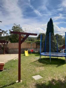 a playground with a trampoline in the grass at Gyarmati vendégház in Sirok