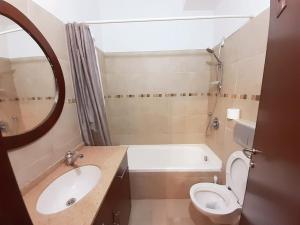 a bathroom with a sink and a toilet and a tub at Family Apartment near Old City in Jerusalem +10 photos