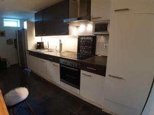 a kitchen with a sink and a stove top oven at Bello Apartamento in Graben-Neudorf