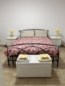 a bed in a room with two night stands and two tables at B&B Cloè in Pregassona