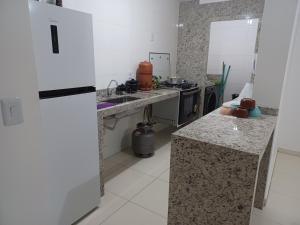 uma cozinha com bancadas em granito e um fogão em Aluga-se quarto em apartamento em Ipatinga