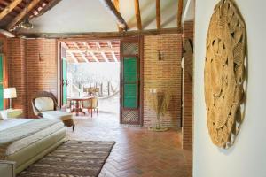 a bedroom with a bed and a dining room at Castillete in Cartagena de Indias