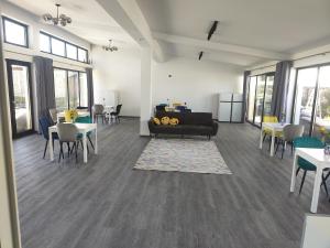 a living room with a couch and tables and chairs at JAI GIRIDHARI in Avrig