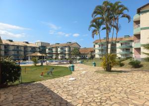 a resort with a playground and palm trees and condos at Aldeia das Aguas Village in Barra do Piraí