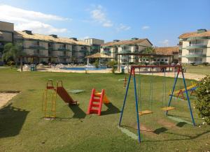 a playground with slides and swings in a park at Aldeia das Aguas Village in Barra do Piraí