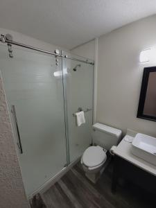 a bathroom with a shower and a toilet and a sink at Jackson Hotel & Convention Center in Jackson