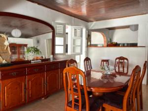 a kitchen with a wooden table and a dining room at Villa à louer à Sainte-Anne en Martinique in Sainte-Anne