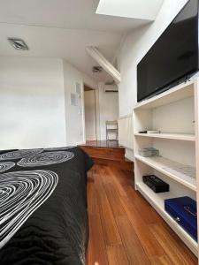 a bedroom with a bed and a flat screen tv at Jacuzzi Apartment - Center Zagreb in Zagreb