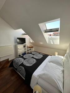 a bedroom with a large bed in a attic at Jacuzzi Apartment - Center Zagreb in Zagreb