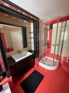 a bathroom with a tub and a sink and a mirror at Jacuzzi Apartment - Center Zagreb in Zagreb